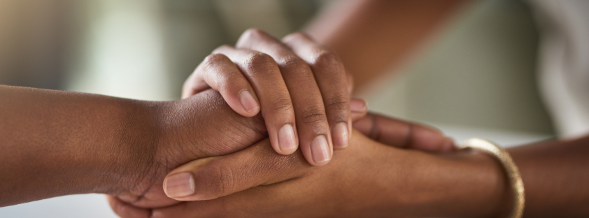 Two black hands holding one another.